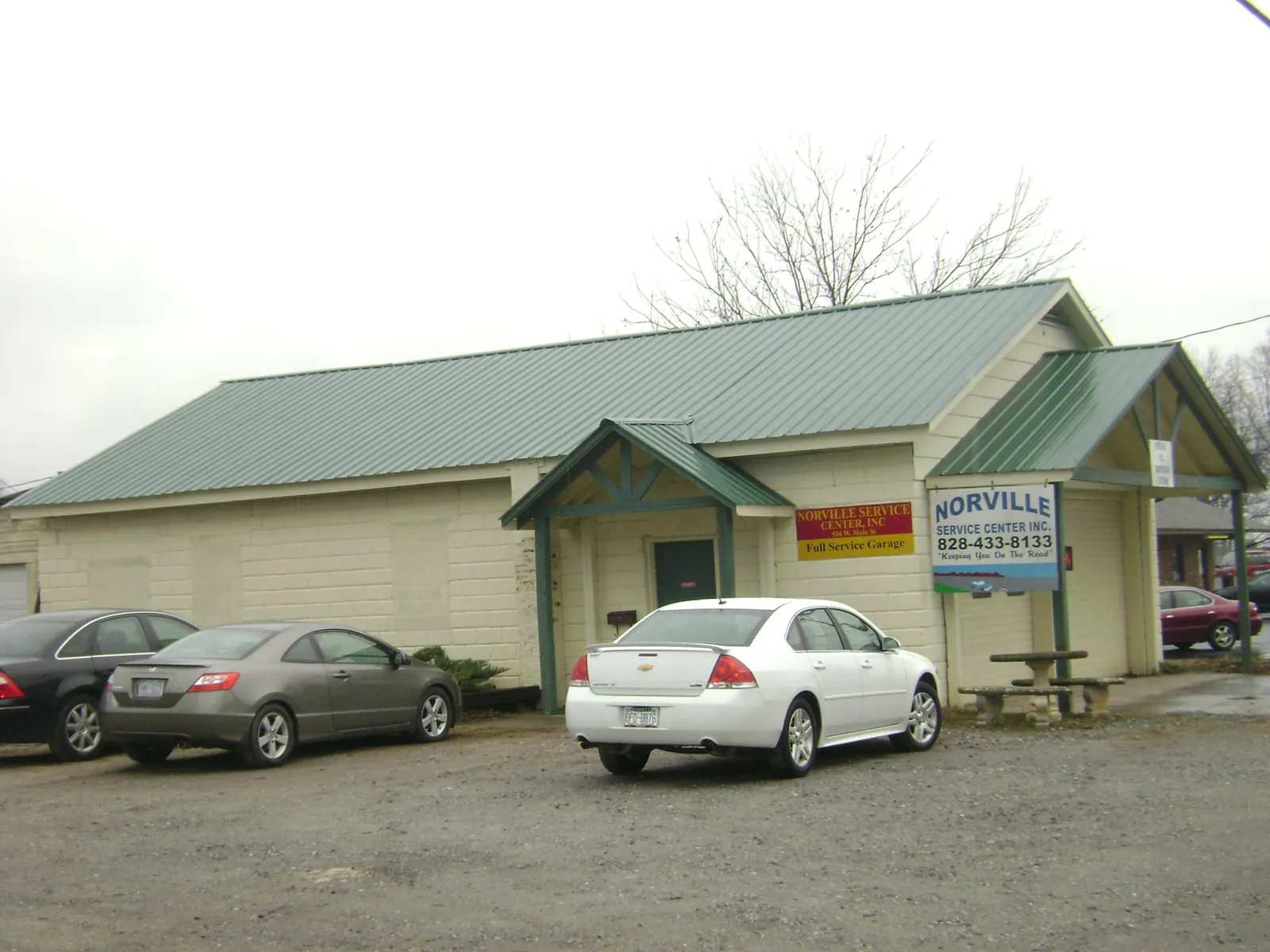 Green metal roof on a service garage with a covered entry in Westfield Center